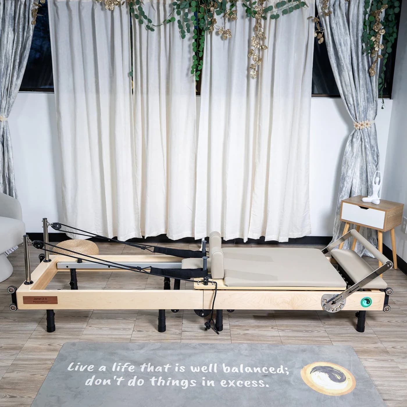 PersonalHour Janet Elite 2.0 foldable Pilates reformer in a studio with a smart screen on a stand